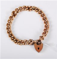 Lot 442 - A gold plated curblink bracelet with heart...