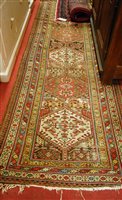 Lot 1193 - A Persian woollen hall runner, the central...