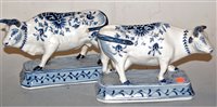 Lot 214 - A pair of Dutch Delft cattle, each raised upon...