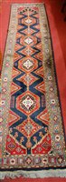 Lot 1202 - A Persian woollen blue ground hall runner,...