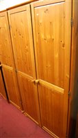 Lot 1139 - A pair of modern pine double door wardrobes,...