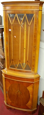 Lot 1131 - A reproduction yew wood freestanding corner...