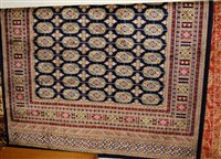 Lot 1207 - A machine woven Persian blue ground Bokhara...