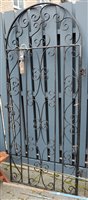 Lot 1160 - A black painted wrought iron arched single...