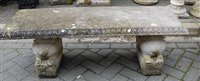 Lot 1167 - A reconstituted stone low garden bench seat,...