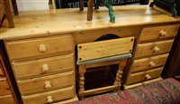 Lot 1187 - A modern pine long kneehole dressing table,...