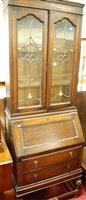 Lot 1255 - A 1920s moulded oak and lead glazed bureau...