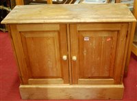 Lot 1295 - A modern pine double door low side cupboard, w....