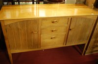 Lot 1309 - A 1950s faded walnut sideboard, having three...