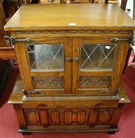 Lot 1366 - A moulded oak linenfold panelled hinged top...