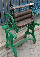 Lot 1210 - A green painted cast iron freestanding mangle