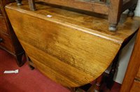 Lot 1439 - A 19th century oak drop leaf dining table...