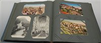 Lot 590 - An early 20th century postcard album and...