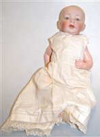 Lot 609 - A 20th century bisque head doll having blue...