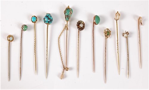 Lot 2556 - Eleven gemset stick pins: to include a 15ct...
