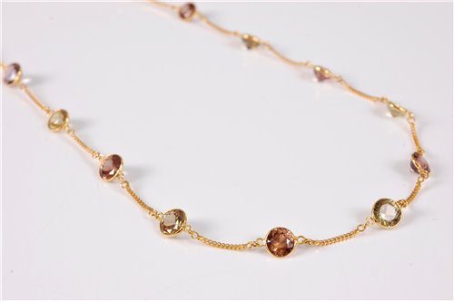 Lot 1277 - A 14k zircon necklace, the round spectacle set...