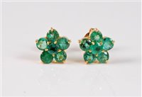 Lot 1248 - A pair of emerald flowerhead cluster earstuds,...