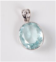 Lot 1218 - An aquamarine pendant, the oval mixed cut...