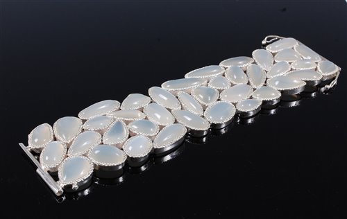 Lot 1266 - A contemporary moonstone cuff/bracelet, the...