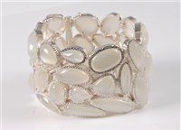 Lot 1266 - A contemporary moonstone cuff/bracelet, the...