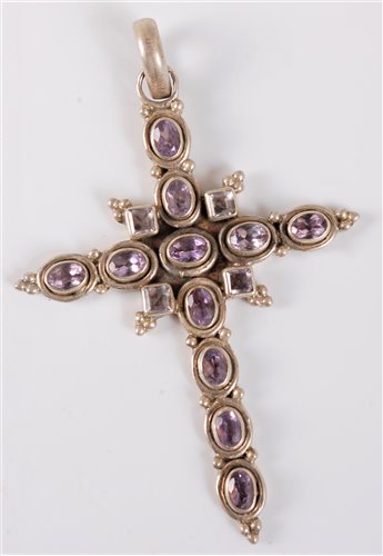 Lot 1322 - A silver and amethyst cross, the mixed cut...