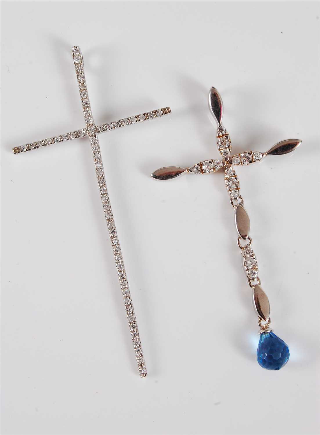 Lot 335 - Two silver and gemset cross pendants, the...