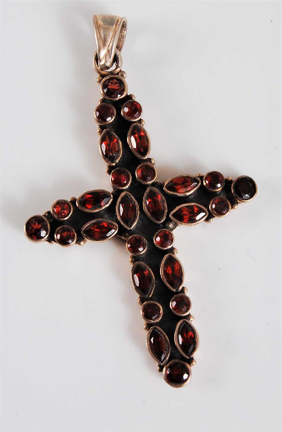 Lot 336 - A silver and garnet cross pendant, with a mix...