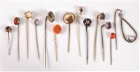 Lot 2561 - Thirteen assorted stick pins: to include...