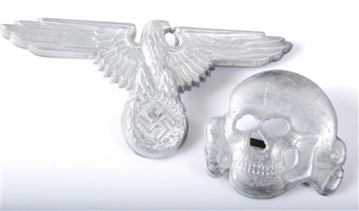 Lot 229 - A German Waffen SS eagle cap badge, together with a skull example. (2)