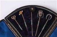 Lot 2565 - A cased group of six stick pins: to include a...