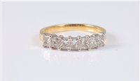 Lot 1307 - An 18ct seven stone diamond ring, the princess...
