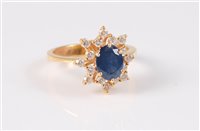 Lot 1239 - An 18ct sapphire and diamond cluster ring, the...