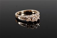 Lot 2596 - A 14k diamond ring, the central graduated...