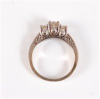 Lot 2596 - A 14k diamond ring, the central graduated...