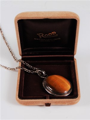 Lot 326 - A tigers eye pendant, the oval cabochon,...