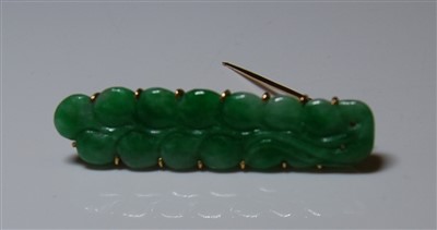 Lot 1286 - A jade brooch, the jade carved as a sprig of...