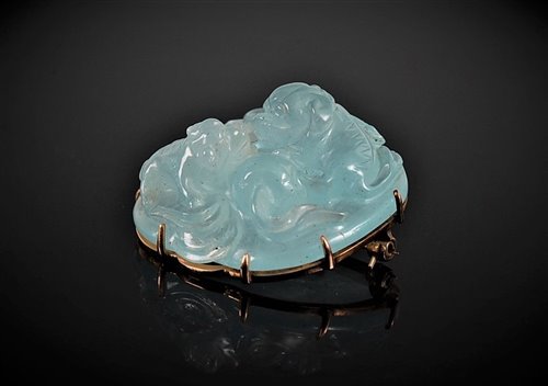Lot 1284 - A Chinese carved aquamarine brooch, the off...