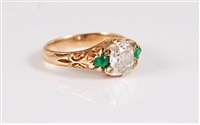 Lot 1257 - A diamond and emerald ring, the central old...