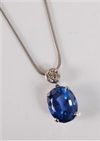 Lot 1254 - A sapphire and diamond pendant, the oval mixed...