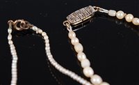 Lot 1316 - Two 'pearl' necklaces, the first a graduated...