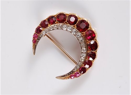 Lot 1268 - A ruby and diamond crescent brooch, the outer...