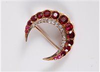 Lot 1268 - A ruby and diamond crescent brooch, the outer...
