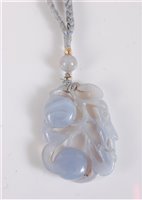 Lot 1288 - A Chinese carved chalcedony pendant, the...