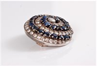 Lot 1298 - A sapphire and diamond spiral brooch, the...
