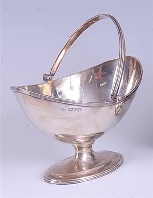 Lot 1206 - A George V silver bonbon basket, having reeded...