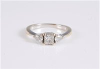 Lot 1238 - An 18ct three stone diamond ring, the central...