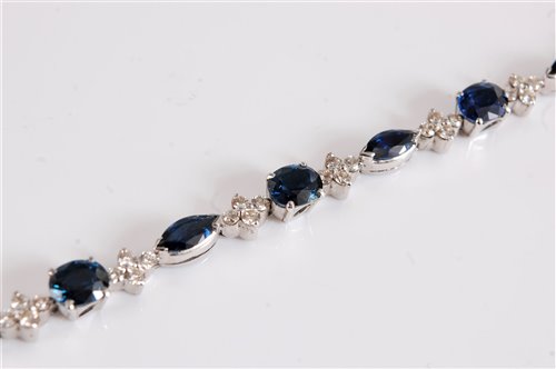 Lot 1222 - An 18ct sapphire and diamond bracelet, the...