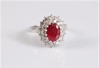 Lot 1282 - An 18ct ruby and diamond cluster ring, the...
