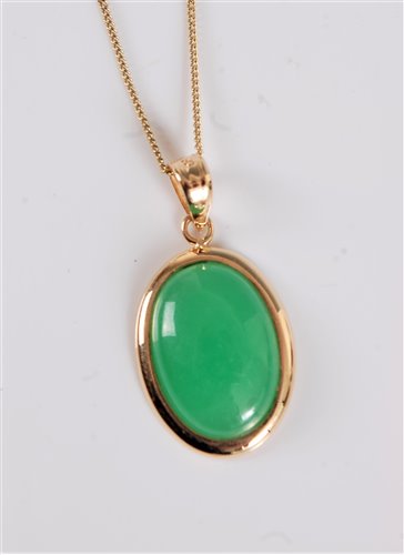 Lot 2611 - A 14k jade pendant, the oval jade cabochon...