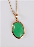 Lot 2611 - A 14k jade pendant, the oval jade cabochon...